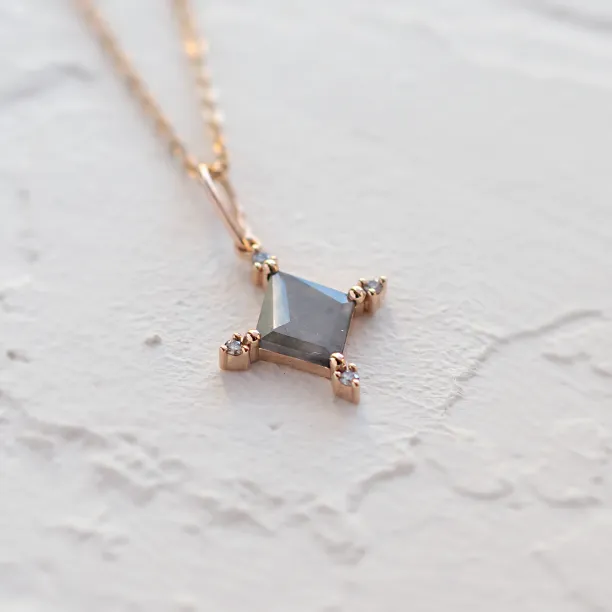 Close-up of the geometric CRESSIDA necklace pendant with visible diamond inclusions