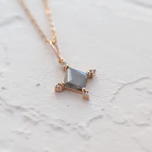 Close-up of the geometric CRESSIDA necklace pendant with visible diamond inclusions