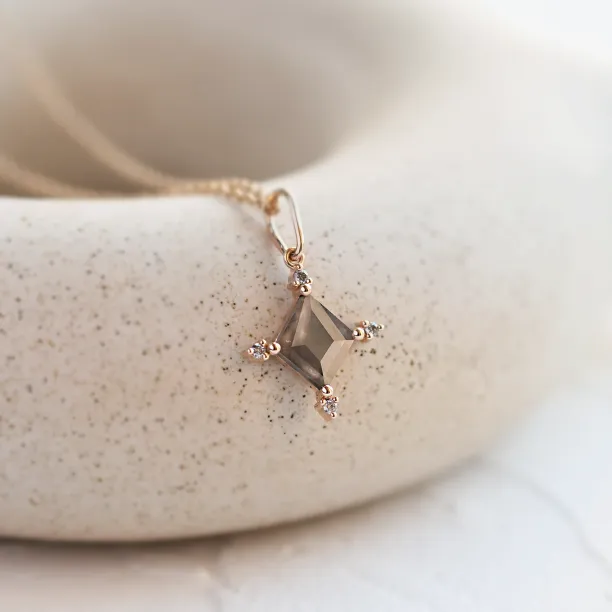 Angled close-up of the CRESSIDA necklace pendant with salt and pepper diamond
