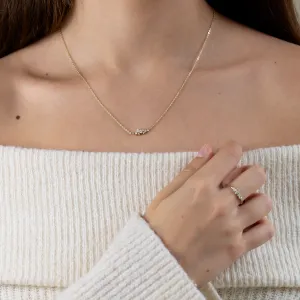 KLAREEN lab-grown diamond cluster necklace worn with a hand touching the pendant