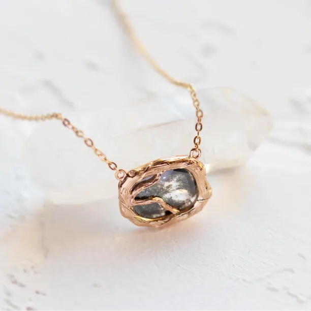 Close-up of the TREASURE necklace’s salt and pepper diamond pendant