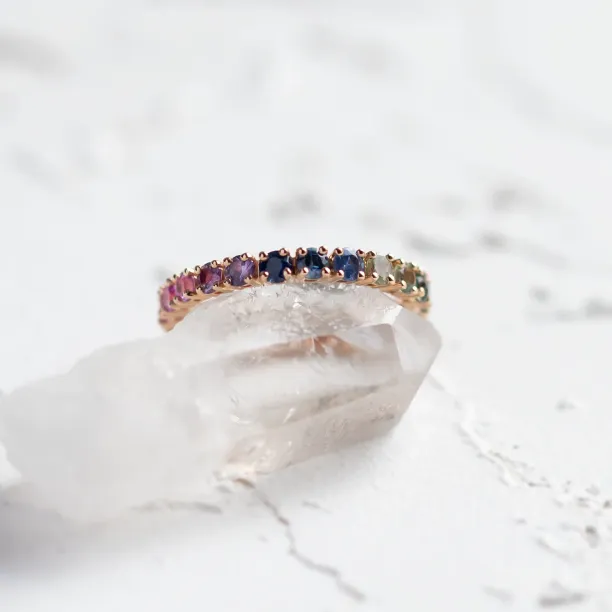 Angled close-up of the MOSAIC ring with colorful sapphires