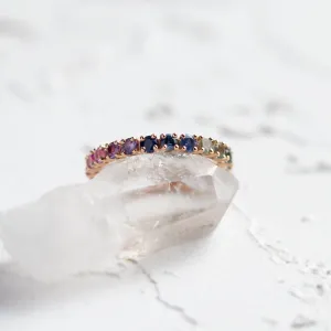 Angled close-up of the MOSAIC ring with colorful sapphires