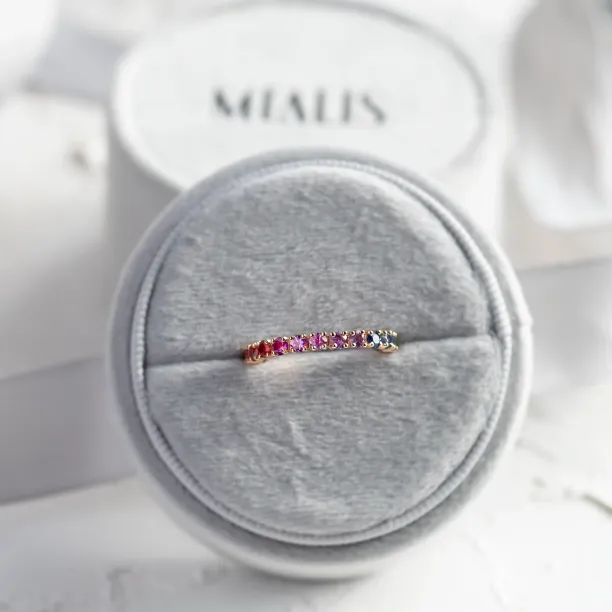 MOSAIC rainbow sapphire ring displayed on a jewelry cushion
