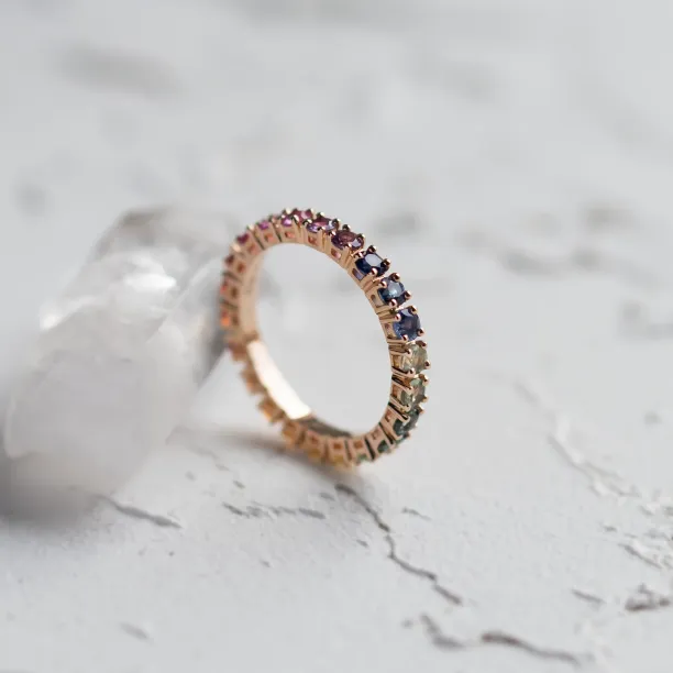 Angled view of the rainbow sapphire eternity ring showing its inner surface