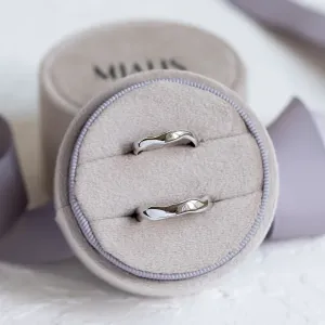Pair of irregular platinum wedding rings displayed from above