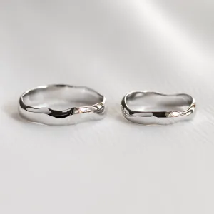 Pair of irregular platinum wedding rings shown separately