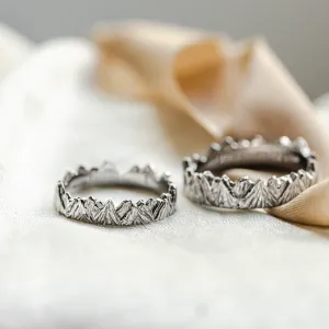 MONTE platinum mountain-inspired wedding rings, shown as a pair
