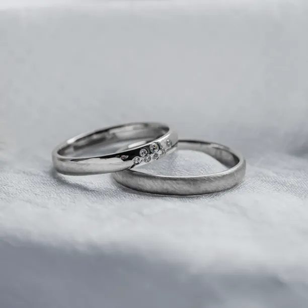 LEOS platinum wedding ring pair with diamonds in an angled view