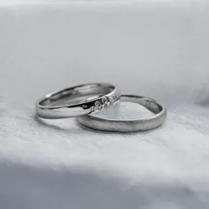 LEOS platinum wedding ring pair with diamonds in an angled view