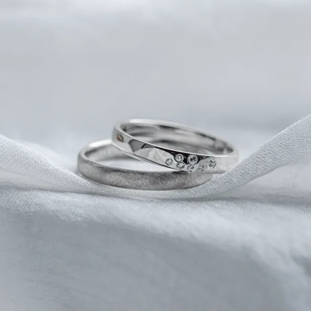 Overlapping LEOS platinum wedding rings with diamonds and contrasting finishes