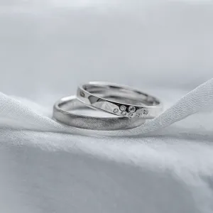 Overlapping LEOS platinum wedding rings with diamonds and contrasting finishes