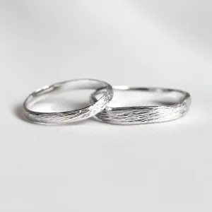 Platinum twig wedding rings MIOS with textured tree-bark surfaces
