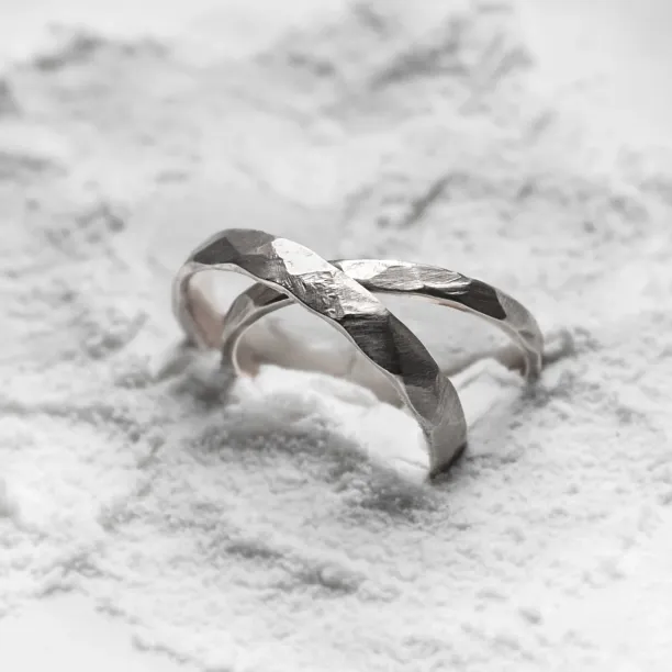 Close-up of ETA platinum wedding bands with hammered surfaces