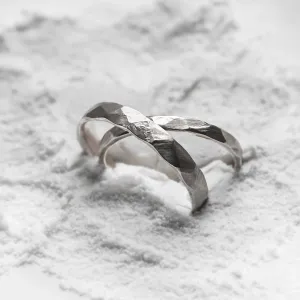 Close-up of ETA platinum wedding bands with hammered surfaces