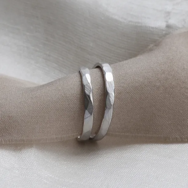 ETA pair of matte platinum wedding bands with hammered surfaces