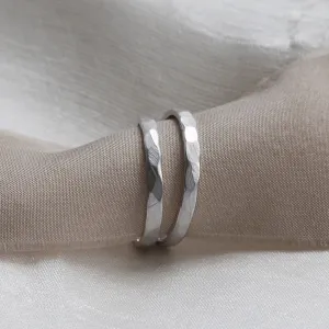 ETA pair of matte platinum wedding bands with hammered surfaces