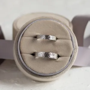 Platinum wedding bands shown from above, highlighting their textured surfaces