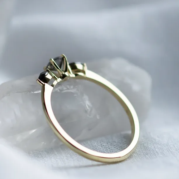 Side view of RINA gold ring showing the raised three-diamond setting