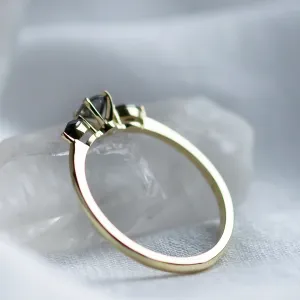 Side view of RINA gold ring showing the raised three-diamond setting
