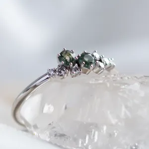 Close-up angled view of the moss agate and diamond cluster ring CLARION