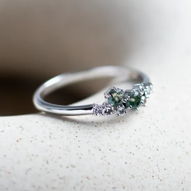 Angled view of the CLARION ring showing its moss agate and diamond cluster