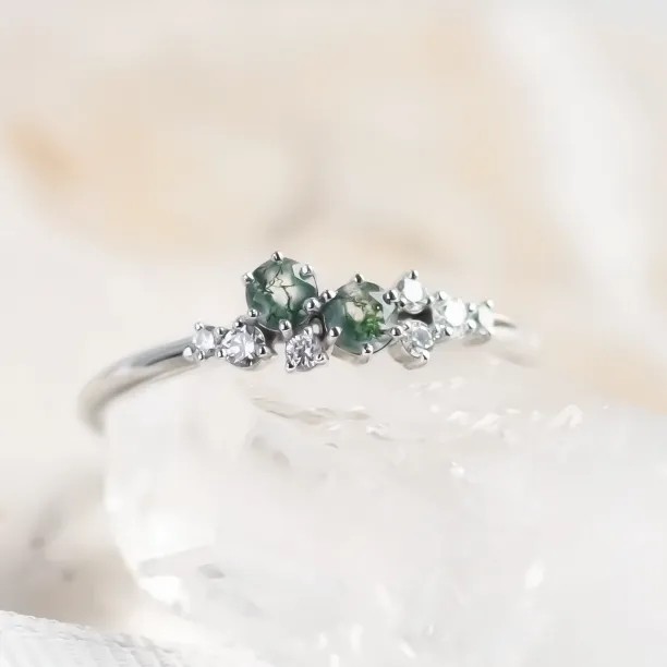 Close-up of the CLARION cluster ring with green moss agates and diamonds
