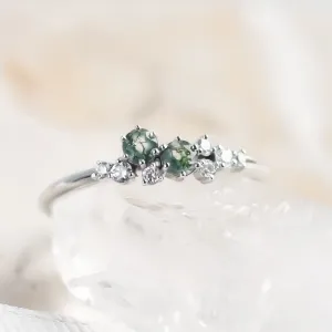 Close-up of the CLARION cluster ring with green moss agates and diamonds