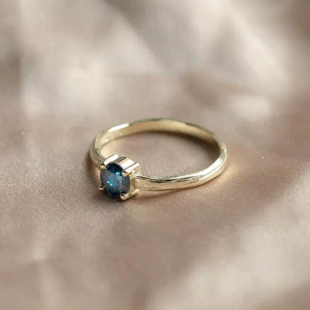 Angled view of the BLU engagement ring with a blue lab-grown diamond