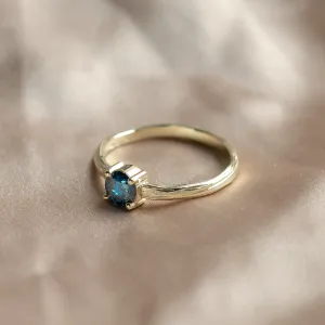 Angled view of the BLU engagement ring with a blue lab-grown diamond