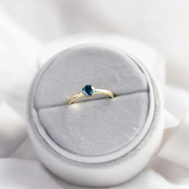 BLU engagement ring with a blue lab-grown diamond on a ring holder