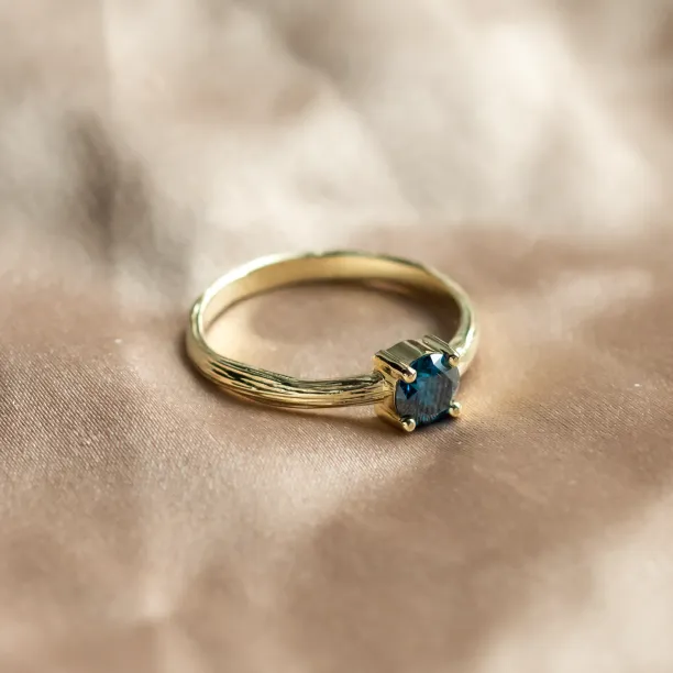 Side view of the BLU engagement ring with a blue lab-grown diamond
