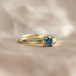Close-up of BLU nature-inspired engagement ring with a blue lab grown diamond