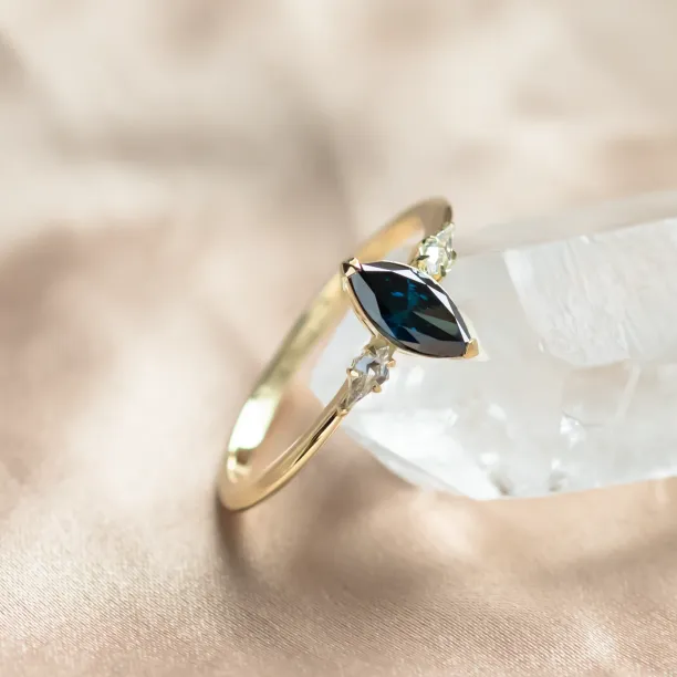 Close-up of the ADINA ring showing its blue marquise diamond and side diamonds