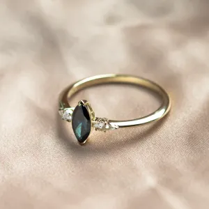 Angled view of the ADINA gold ring with its blue marquise diamond