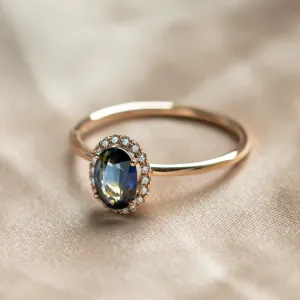 Angled view of the ZARIA teal sapphire and diamond halo ring