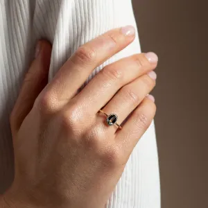 ZARIA teal sapphire and diamond halo ring worn on a hand
