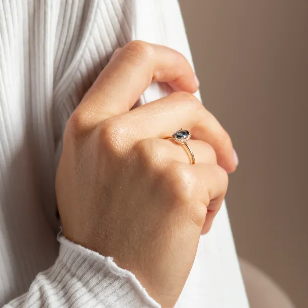 Angled view of the ZARIA halo ring worn on the hand