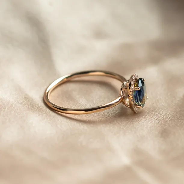 Side view of the ZARIA ring showing its raised teal sapphire setting