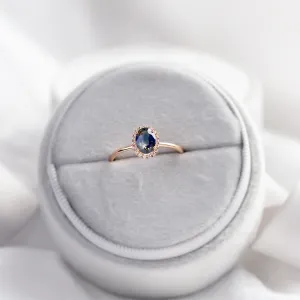 ZARIA halo ring with teal sapphire and diamonds, angled product view