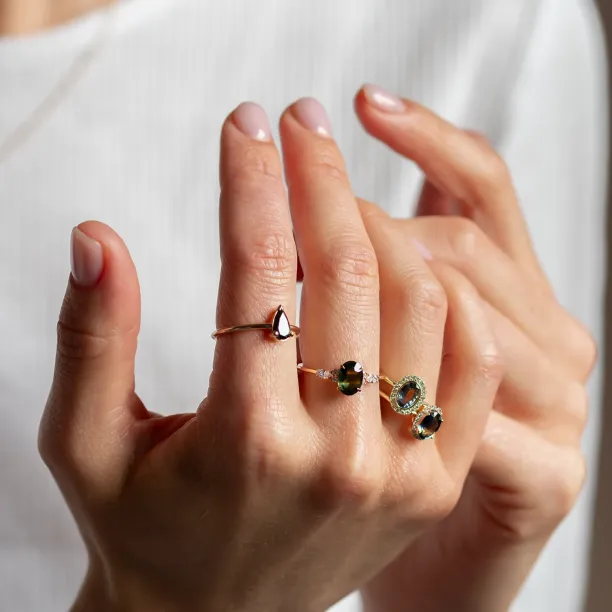 ZARIA halo teal sapphire and diamond ring worn on a hand