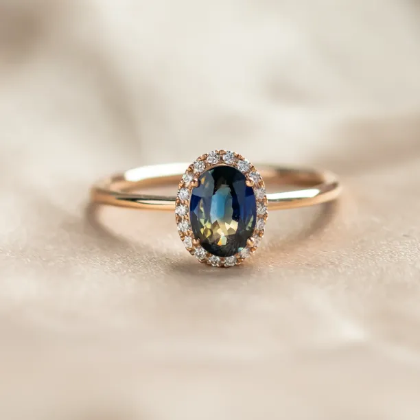 ZARIA halo ring with a teal sapphire surrounded by diamonds