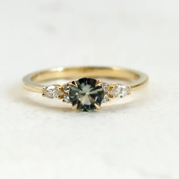 Front close-up of the MAIDEN engagement ring with green sapphire and diamonds