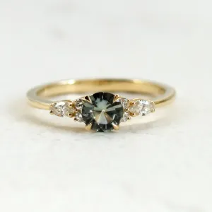 Front close-up of the MAIDEN engagement ring with green sapphire and diamonds