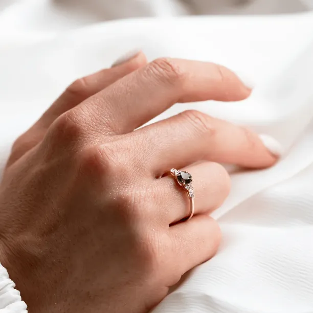 MAIDEN engagement ring with natural green sapphire and diamonds worn on a hand