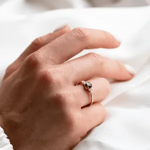 MAIDEN engagement ring with natural green sapphire and diamonds worn on a hand