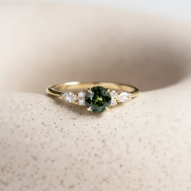 Angled view of the MAIDEN engagement ring with sapphire and diamonds