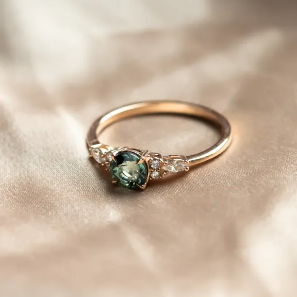 MAIDEN gold engagement ring with natural green sapphire and side diamonds