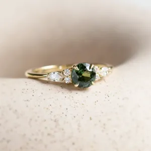 Close-up of the MAIDEN ring’s green sapphire and diamond details