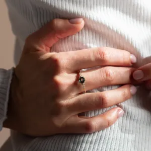 MAIDEN engagement ring with green sapphire and diamonds worn on the finger